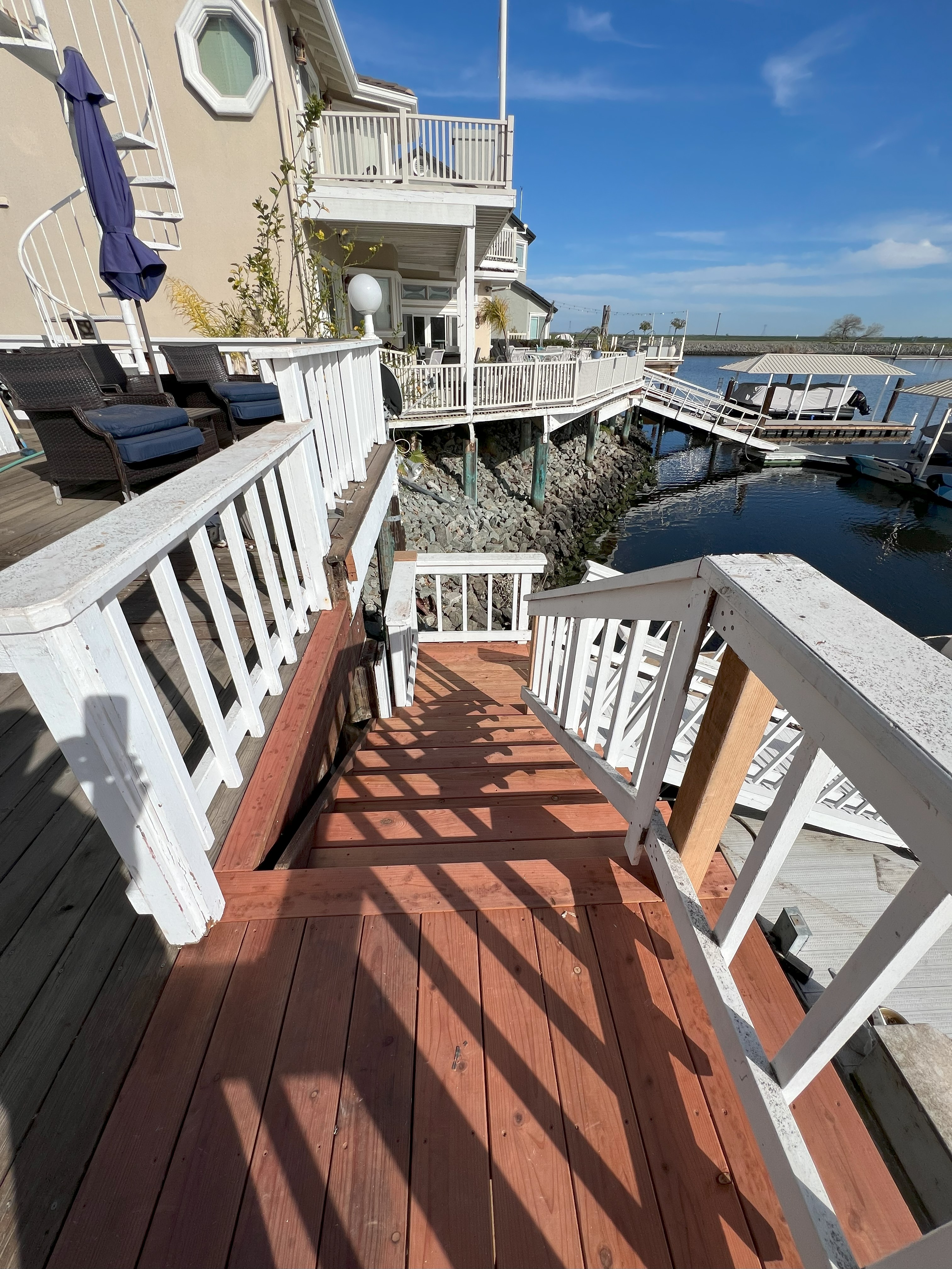 New redwood waterfront steps connecting a Discovery Bay home to the dock